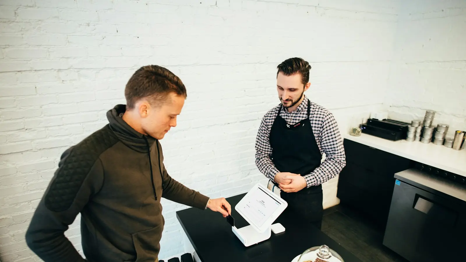 Café owner serving a customer at the counter