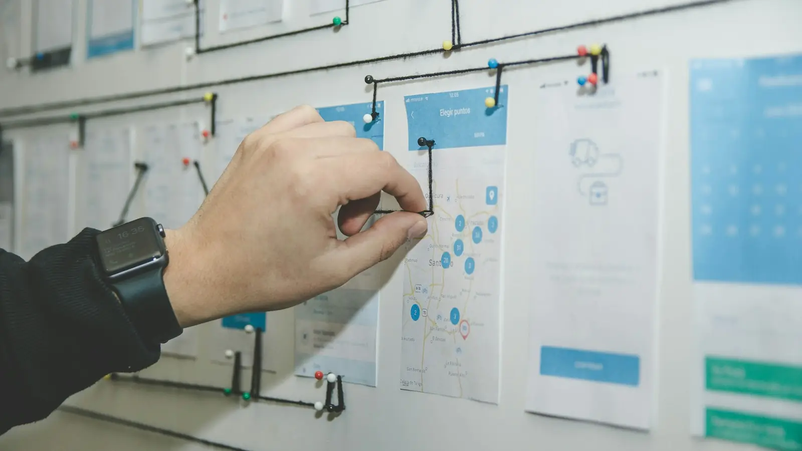Person arranging notes on a planning board