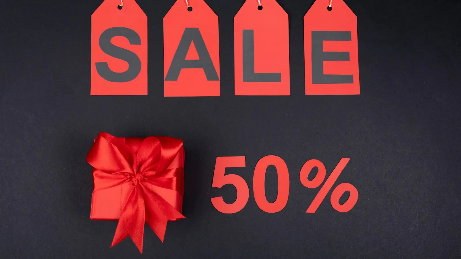 Sale sign with a red gift bow