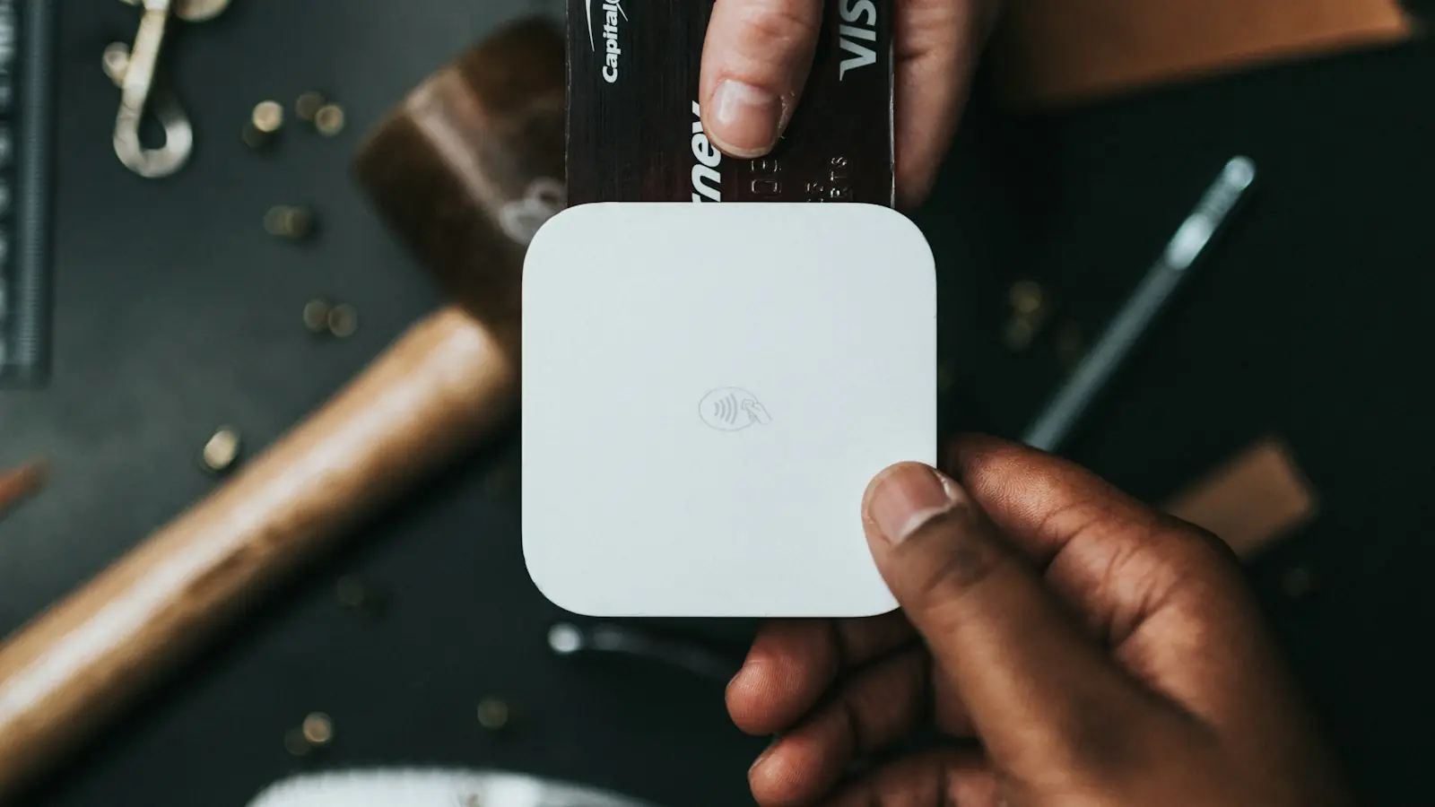 Hand holding a card payment terminal