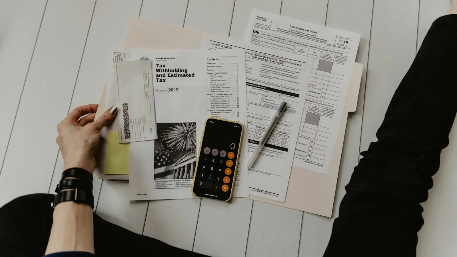 Calculator, smartphone and paperwork on a desk
