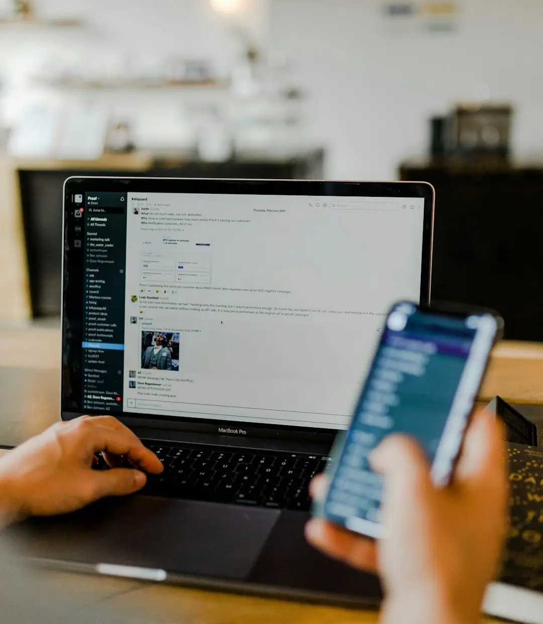 Person managing customer chats on a laptop and phone