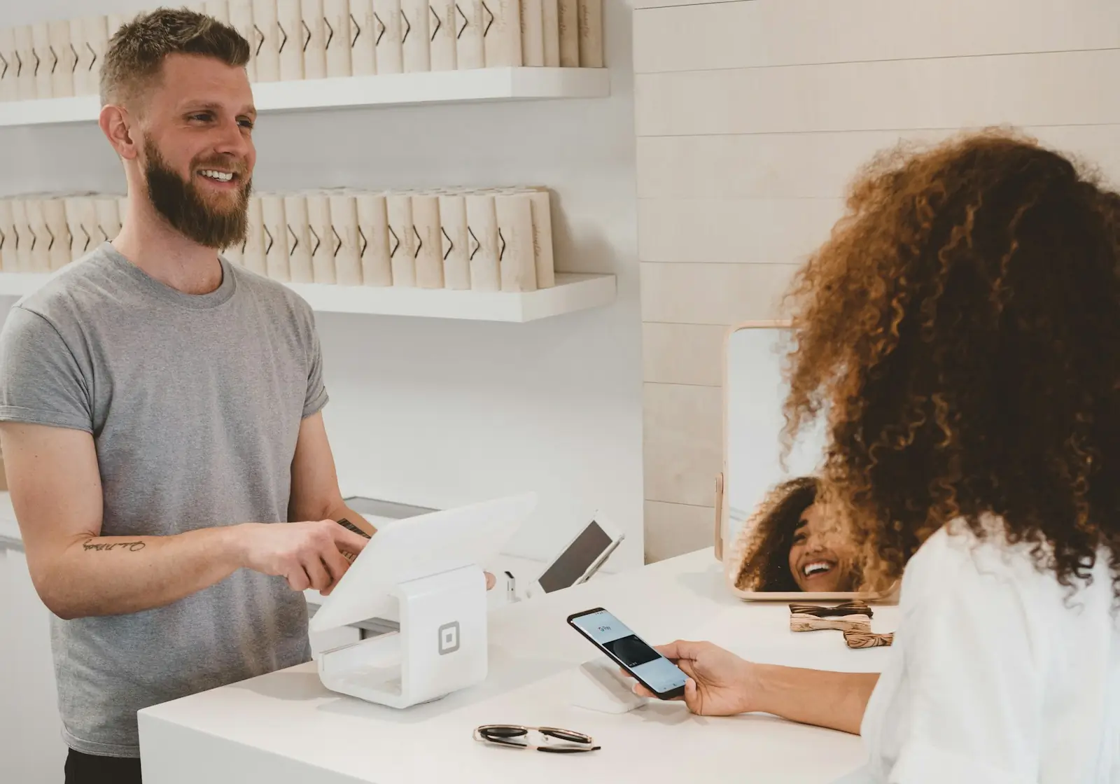 Shop assistant helping a customer at the counter